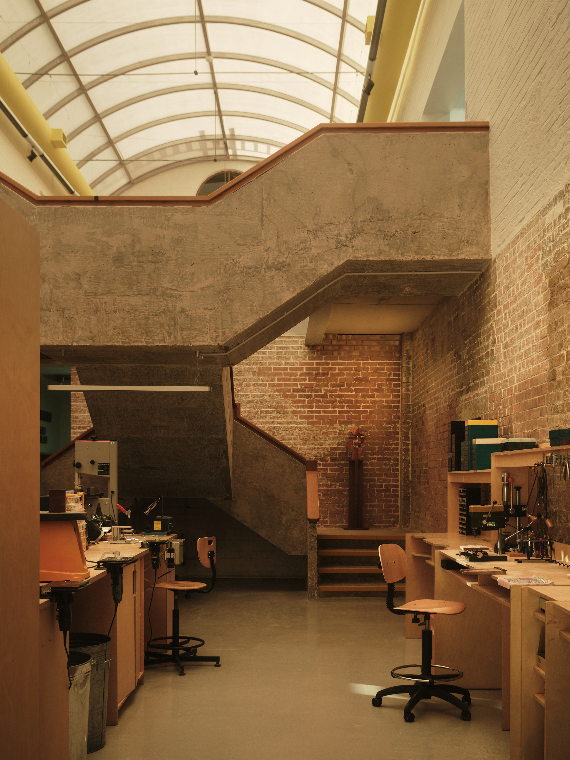 new Cubitts headquarters interior, refurbished warehouse type building with raw materiality and colour pops