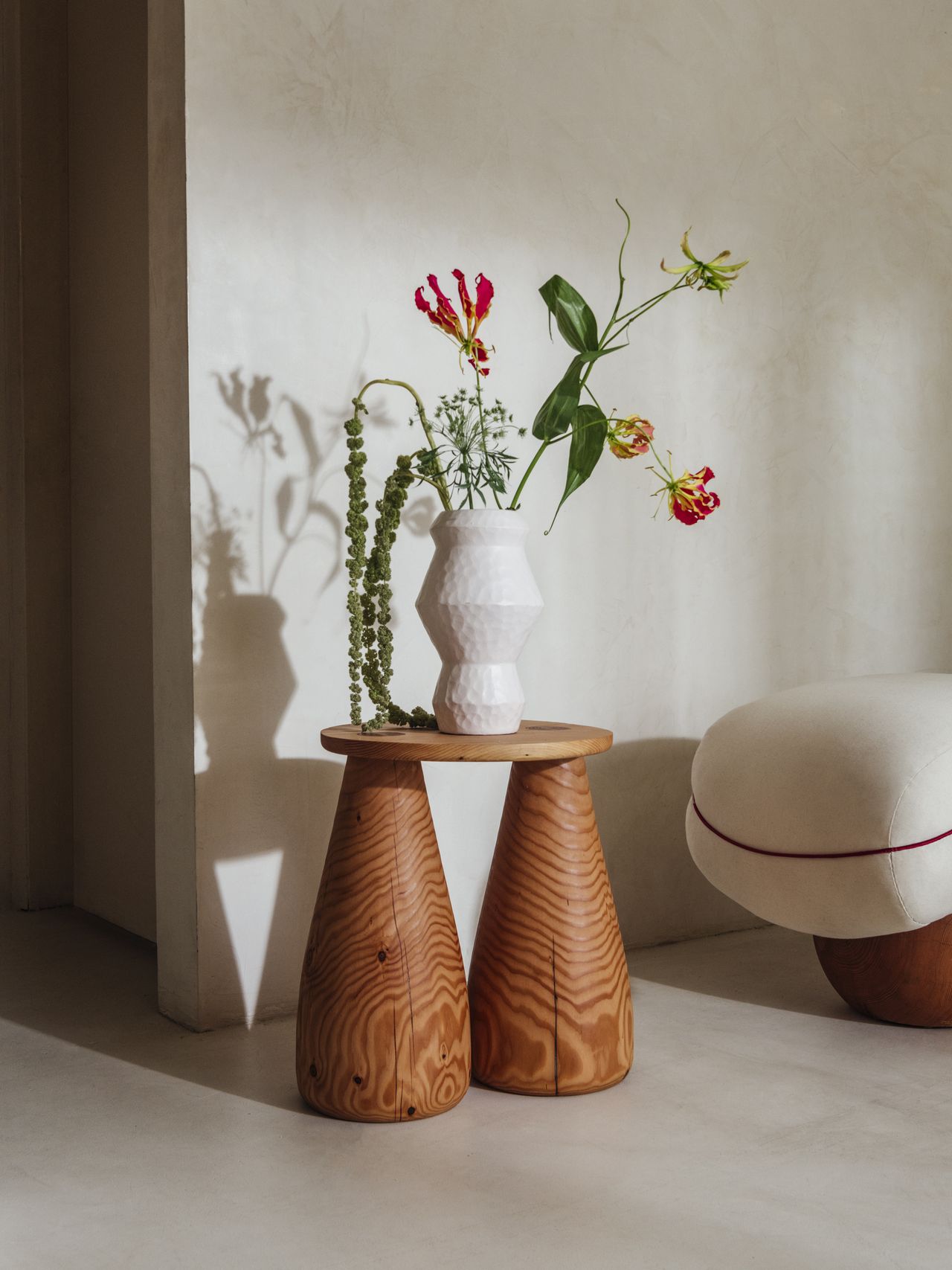 Chunky-looking furniture items including armchairs, chairs, stools, coffee tables, and sofas boast an organic feel and pleasing surface against a cream background.