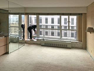 An empty living room with a large window