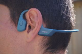 Male cyclist wearing Shokz OpenRun Pro wireless headphones