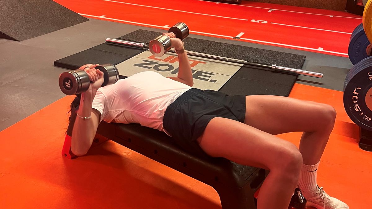 a photo of writer Lucy Gornall doing a dumbbell chest press