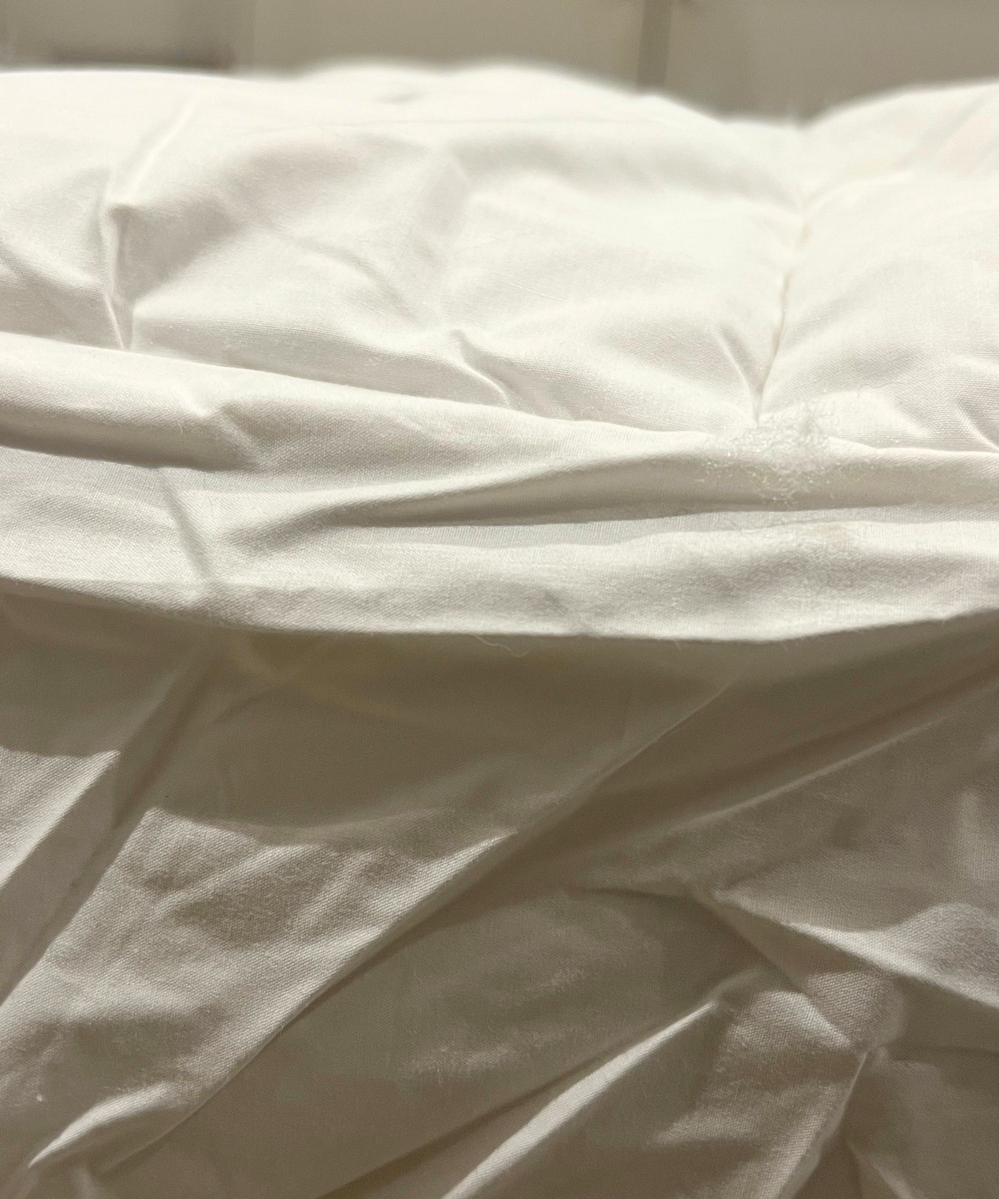 Side view of the Brooklinen Down Alternative Mattress Topper