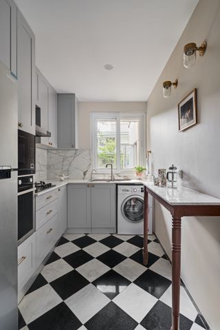 A small kitchen with black and white flooring