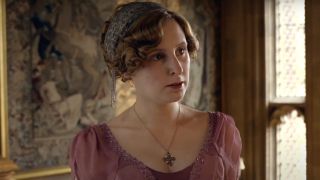 Laura Carmichael stands angrily in a pink dress in Downton Abbey.