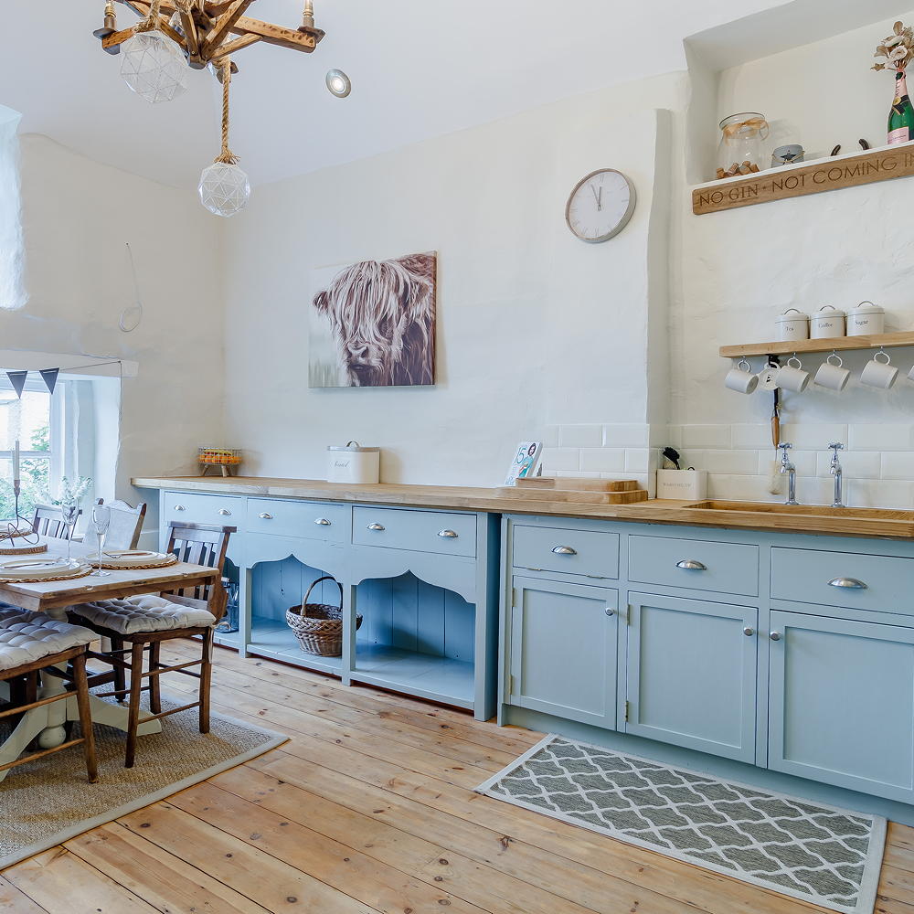 kitchen room with wooden flooring and shelves on wall