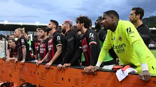 AC Milan players listen in a dialogue with ultras after their 2-0 loss against Spezia in May 2023.