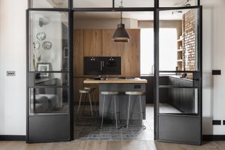 apartment kitchen grey and wood, exposed brick wall, crittal doors