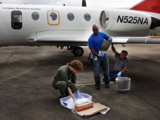 Researcher on NASA's 'bug team' prepare test surfaces to attach to the wings of NASA Langley's HU-25C Falcon aircraft before a flight through the sticky late summer weather in Virginia.