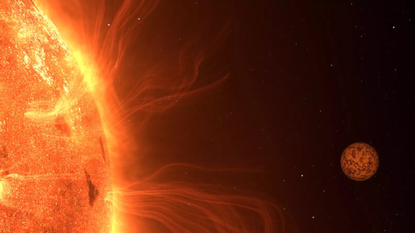 An illustration of Trappist-1 b shortly before it passes behind the cool, red dwarf star, Trappist-1. Such stars are known for their activity with large starspots and eruptions. Trappist-1 b may experience intense volcanism.