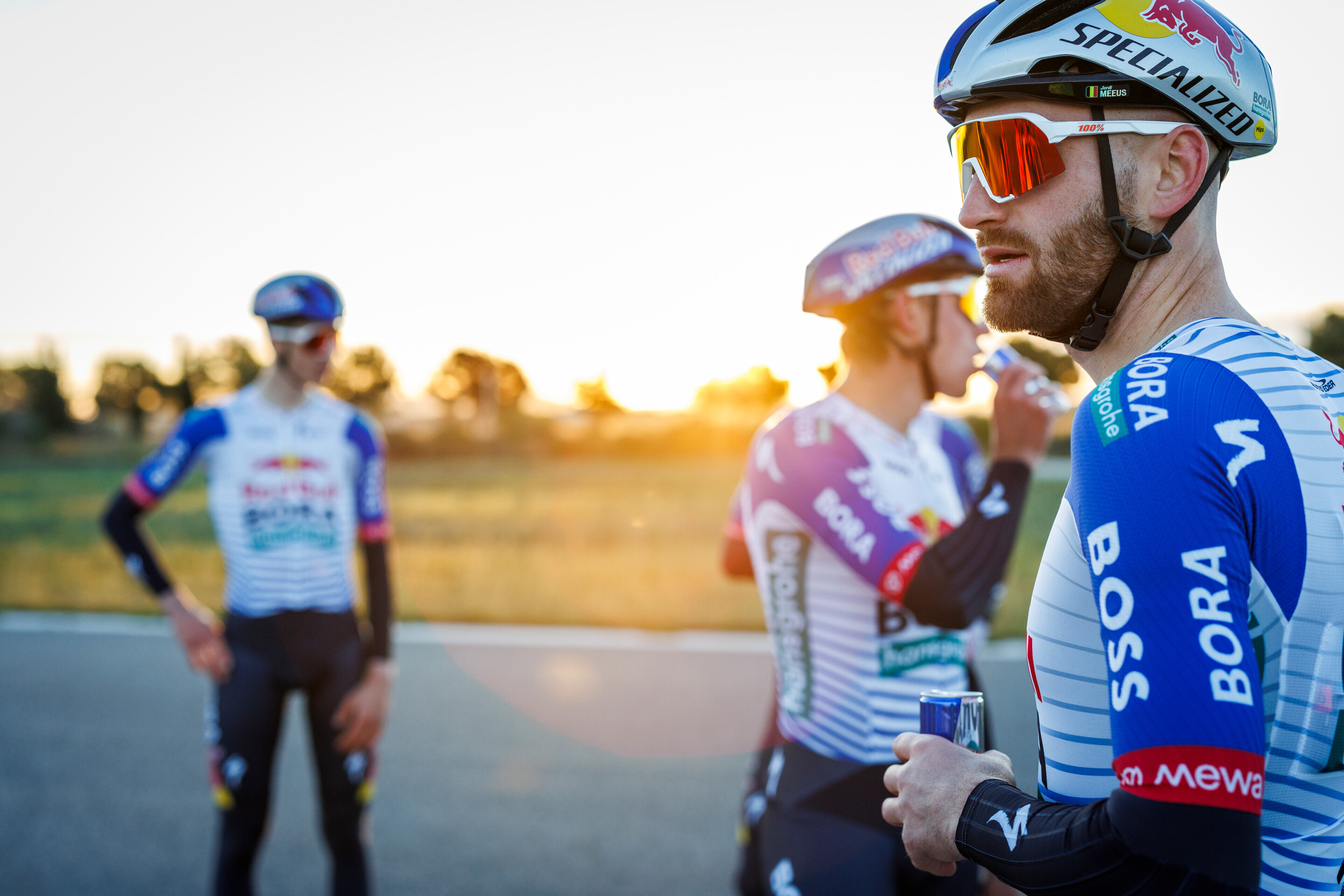 Nine Red Bull-Bora-Hansgrohe riders pulling a plane