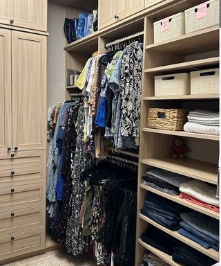 small walk-in wardrobe with pale wood and open shelving