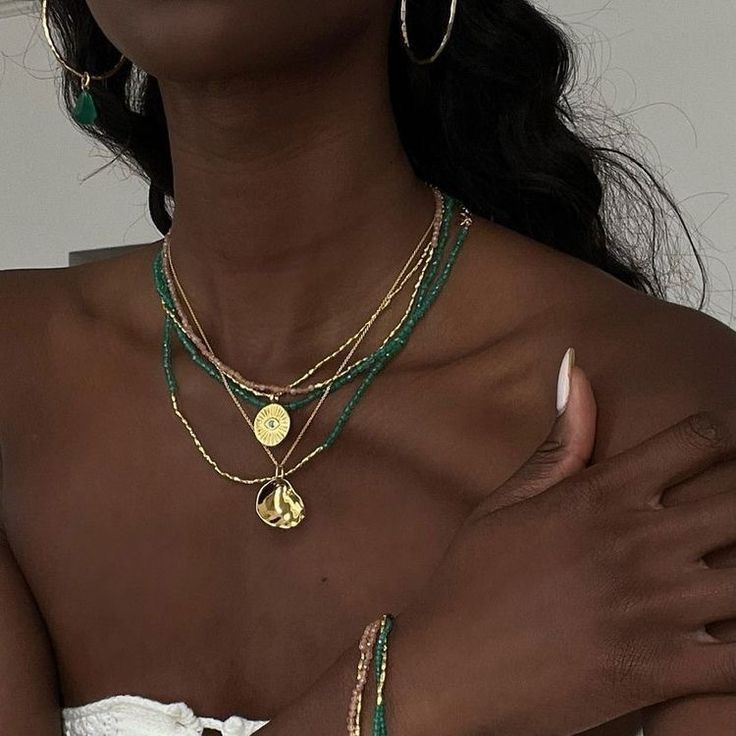 Influencer in Monica Vinader emerald necklace with gold pendent jewellery to layer with