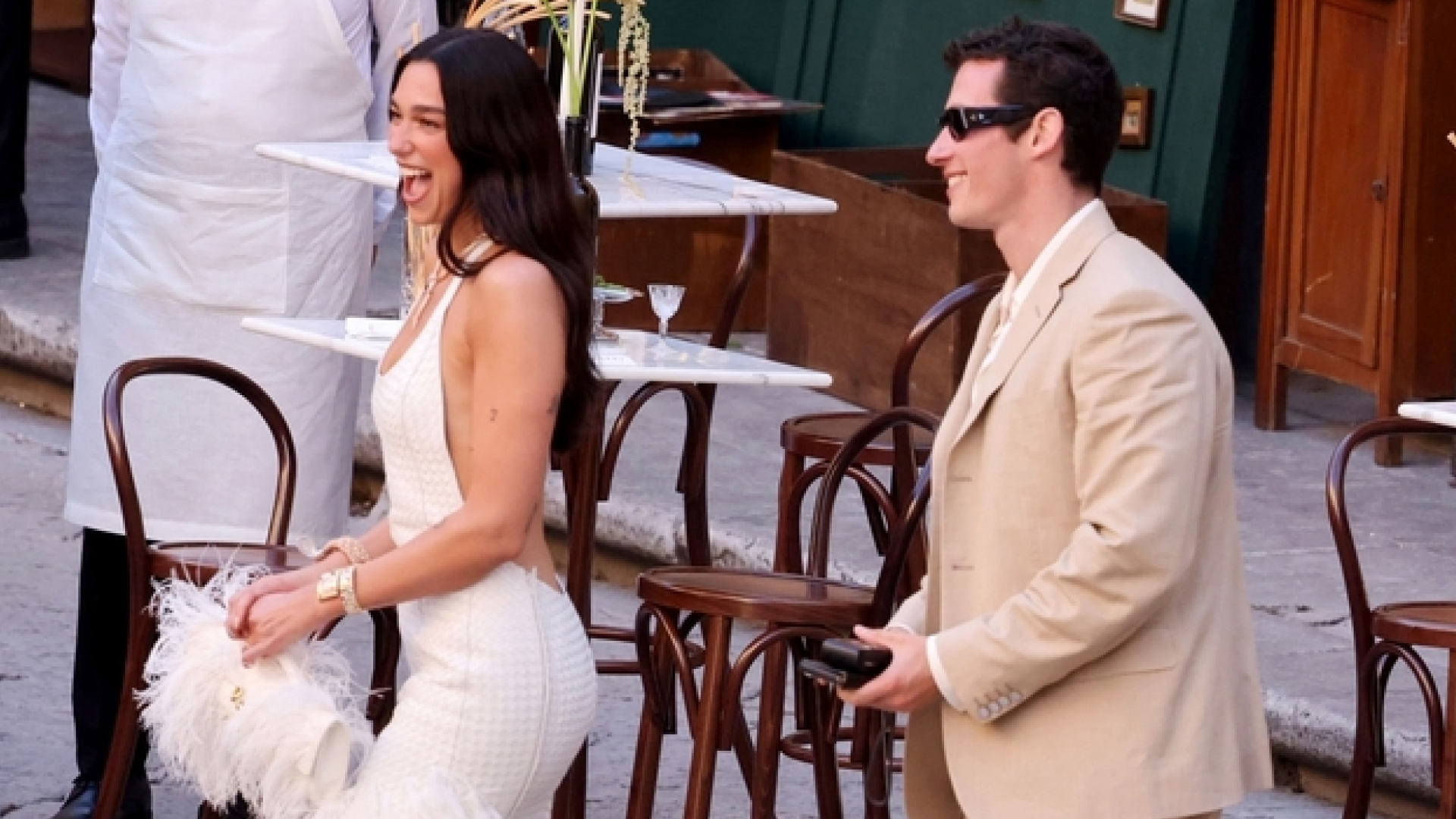 Dua Lipa and Callum Turner entering their wedding welcome party