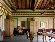 Fig 2: Vestibulum or entrance hall. Imagined as an estate office, a calculus is on the table; the cupboards are based on those depicted on a Roman sarcophagus. The concertina frieze is inspired by one from a 4th-century villa at Rudston, East Yorkshire. Villa Ventorum at The Newt, Somerset. ©Paul Highnam for Country Life