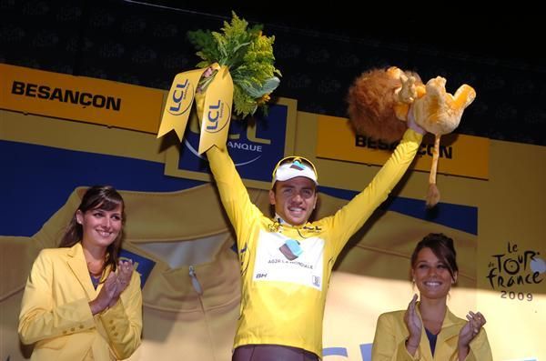 Rinaldo Nocentini (AG2R La Mondiale) astride the Tour podium and resplendent in yellow