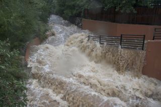 Bear Creek rages with floodwater on Thursday afternoon (Sept. 12, 2013).