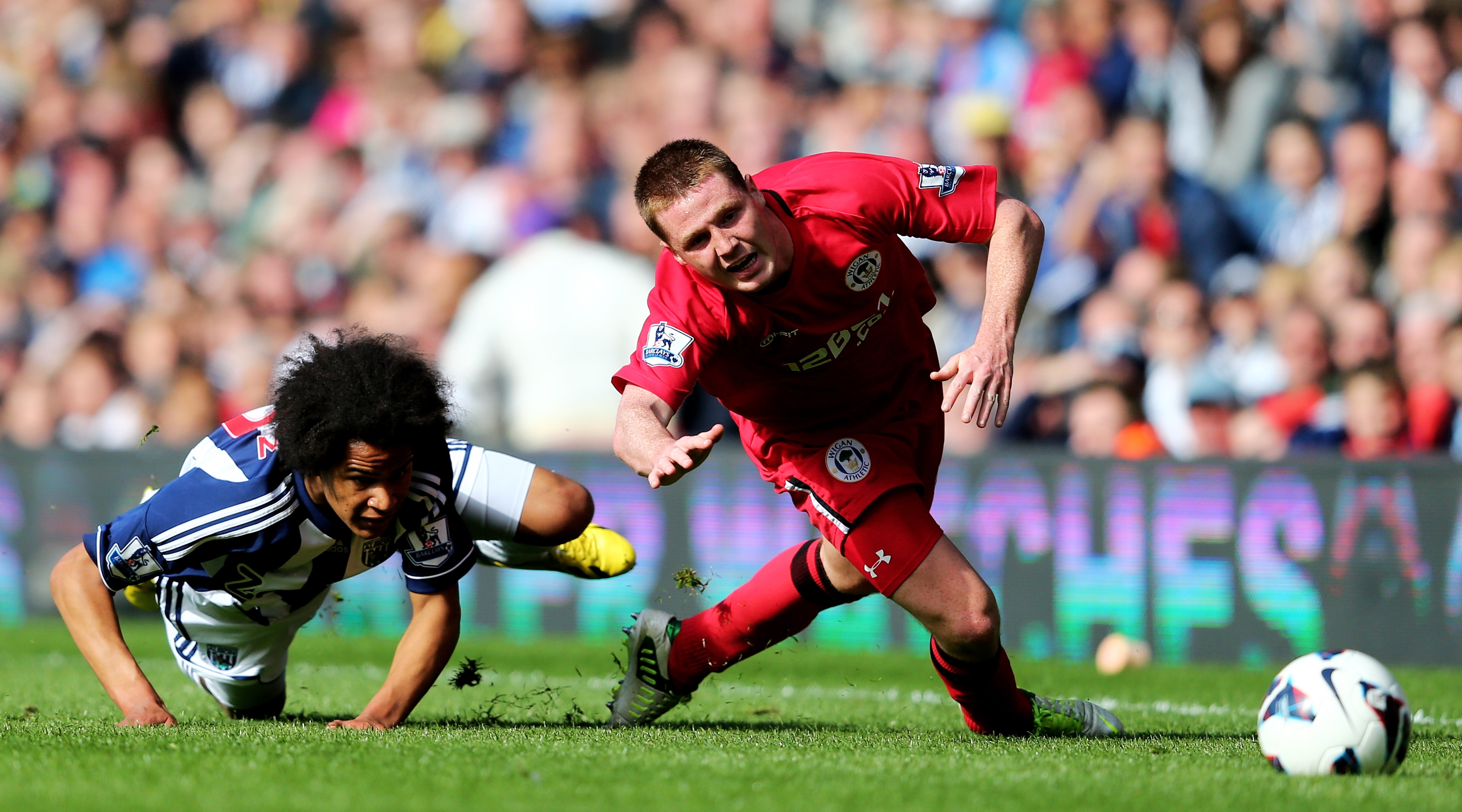 Shaun Maloney of Wigan is brought down by Isaiah Brown of West Bromwich during the Premier League match between West Bromwich Albion and Wigan Athletic at The Hawthorns on May 4, 2013 in West Bromwich, England.
