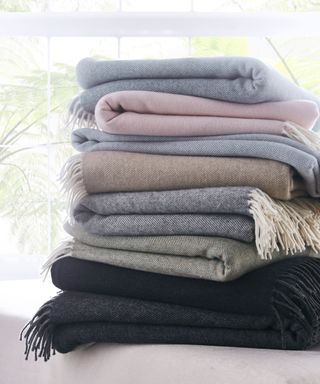 folded blankets in a tall pile