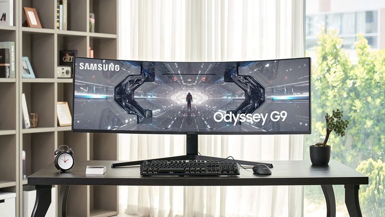 Samsung Odyssey Neo G9 curved gaming monitor shown front on and on a desk