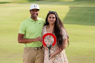Tony Finau and his wife Alayna with the Rocket Mortgage Classic trophy