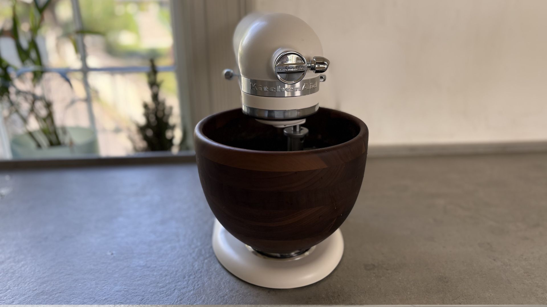 KitchenAid Artisan Stand Mixer with Wooden Bowl on the counter seen from the front