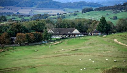 Cleeve Hill Club House with sheep on the fairways