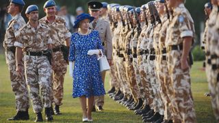Queen Elizabeth II, wearing a blue and white dress with a blue hat, as she inspects UN peacekeeping troops during a visit to Cyprus, 21 October 1993. The Queen is on an official visit to Cyprus, in her capacity as Head of the Commonwealth, to attend the 13th Commonwealth Heads of Government Meeting.