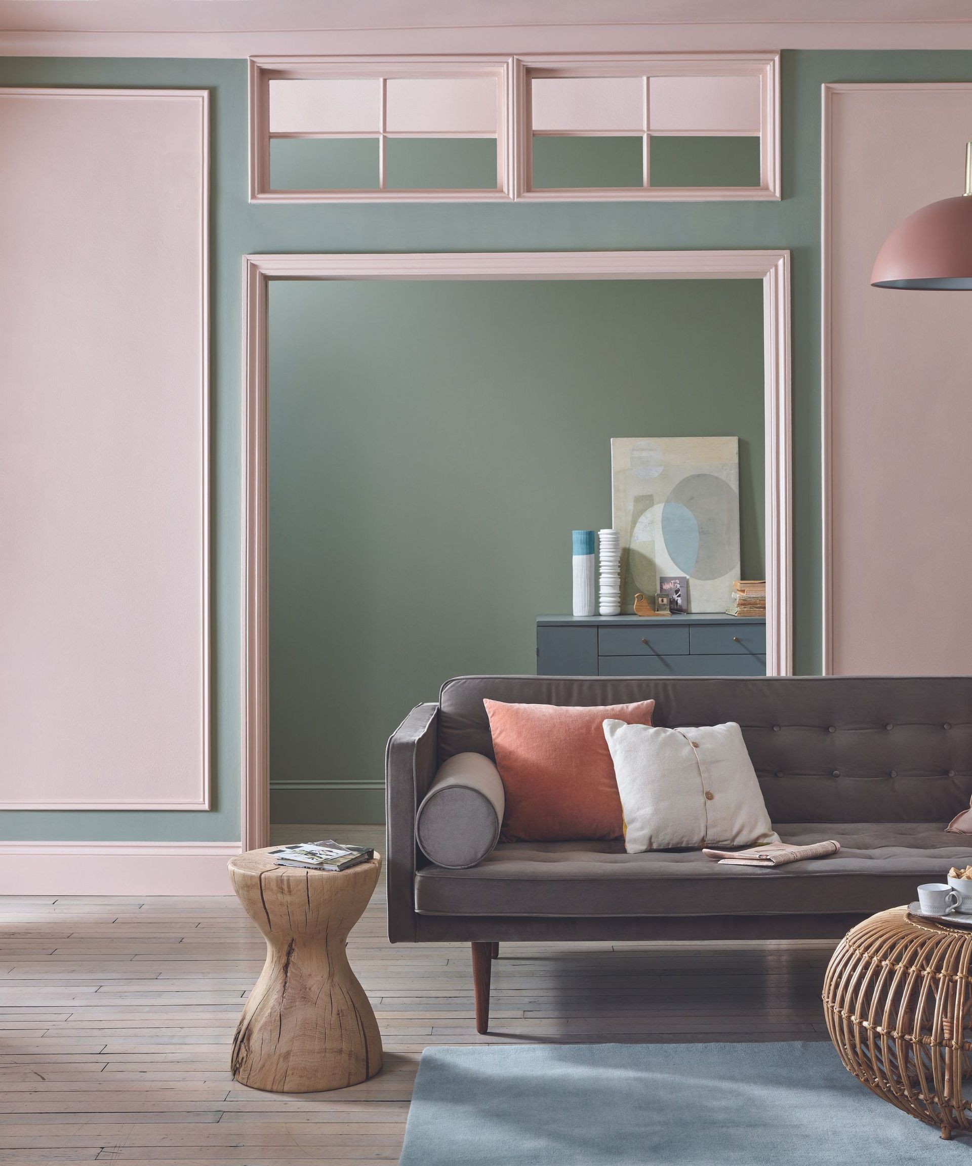 Brown couch in a pink and green living room