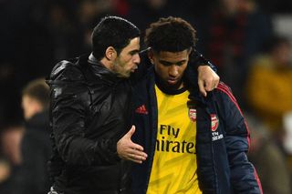 Arsenal's Spanish head coach Mikel Arteta (L) chats with Arsenal's English midfielder Reiss Nelson at the final whistle during the English Premier League football match between Bournemouth and Arsenal at the Vitality Stadium in Bournemouth, southern England on December 26, 2019.
