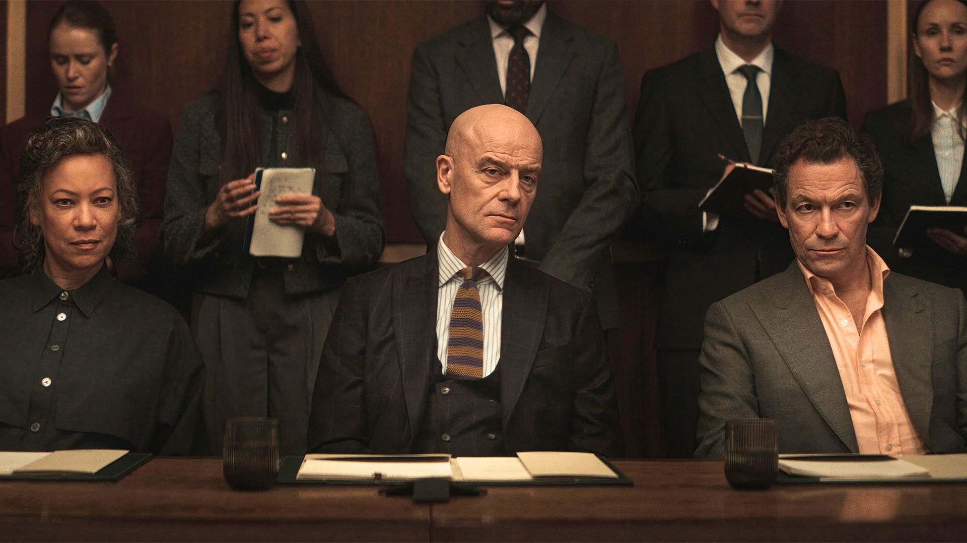Morgan and his lawyers look across a boardroom table