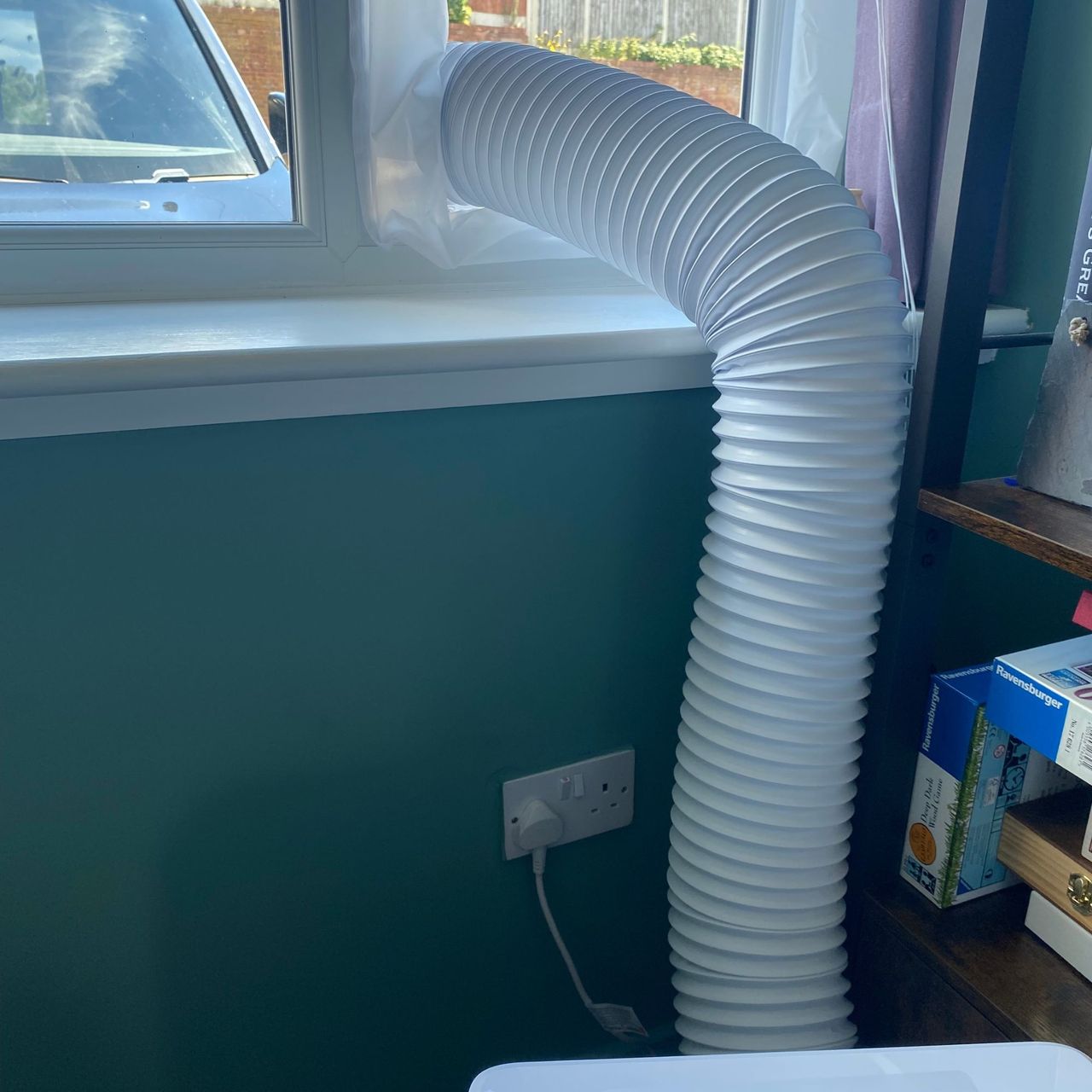 Exhaust hose of the Dreo 318s portable air conditioner vented out of a window