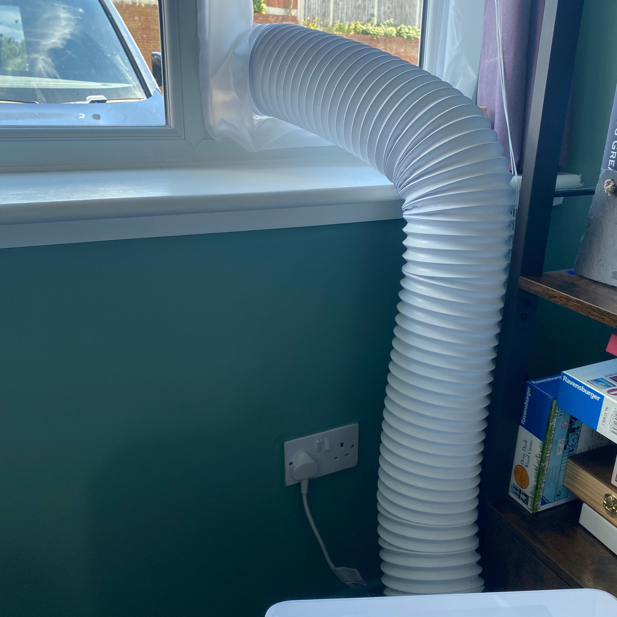 Exhaust hose of the Dreo 318s portable air conditioner vented out of a window