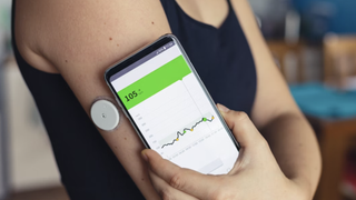 The Zoe blood glucose monitor on someone's arm