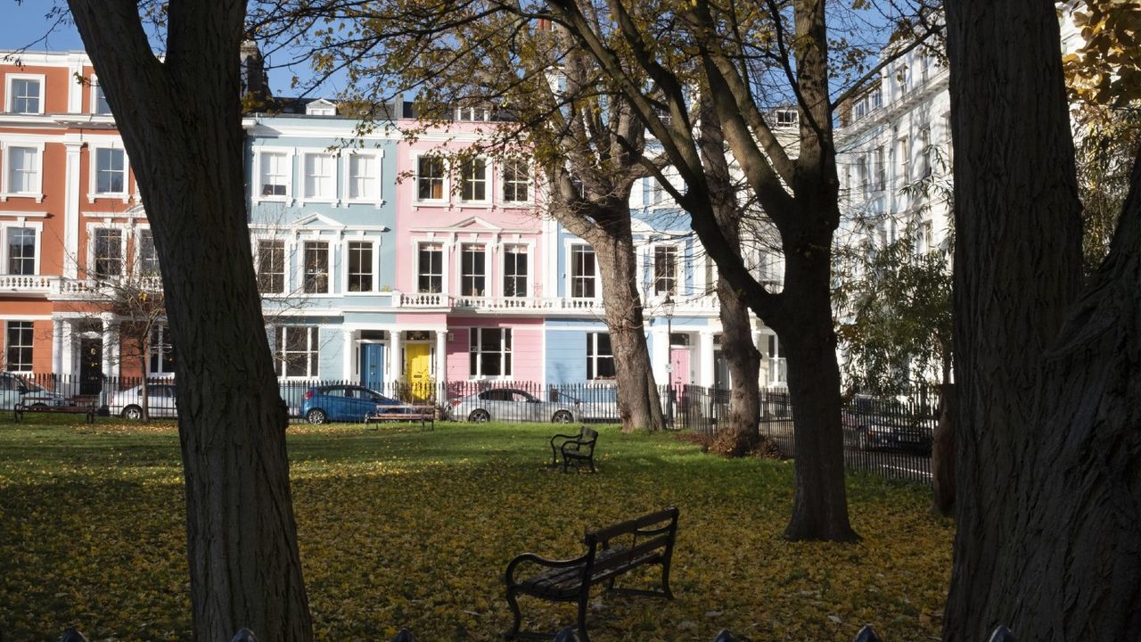 Rows of coloured residential townhouses stand on a square in the Primrose Hill