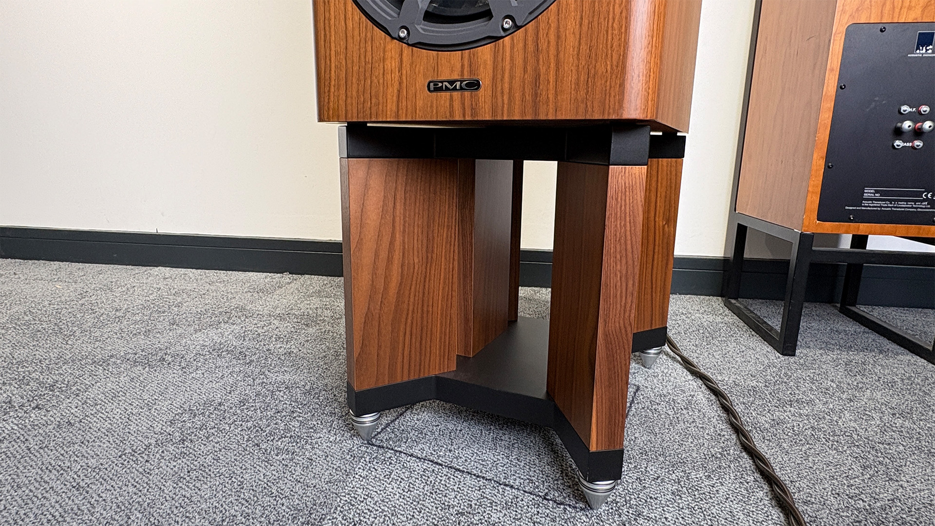 PMC MB2 SE standmount speaker on grey carpet detail of bottom of speaker and stand