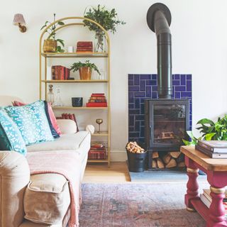 A living room with a wood burning stove and a vintage rug in front of it