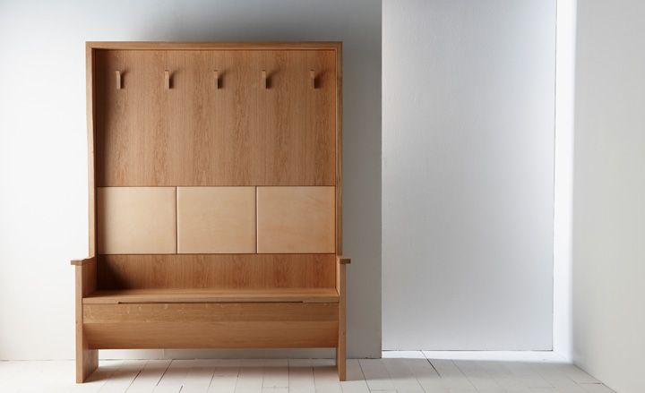 Oak entrance hall seat with hanging space on white wooden floor