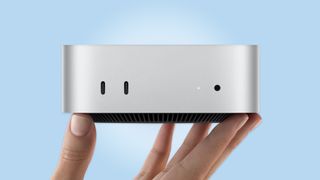 A person holding the new Mac mini with M6 in hand
