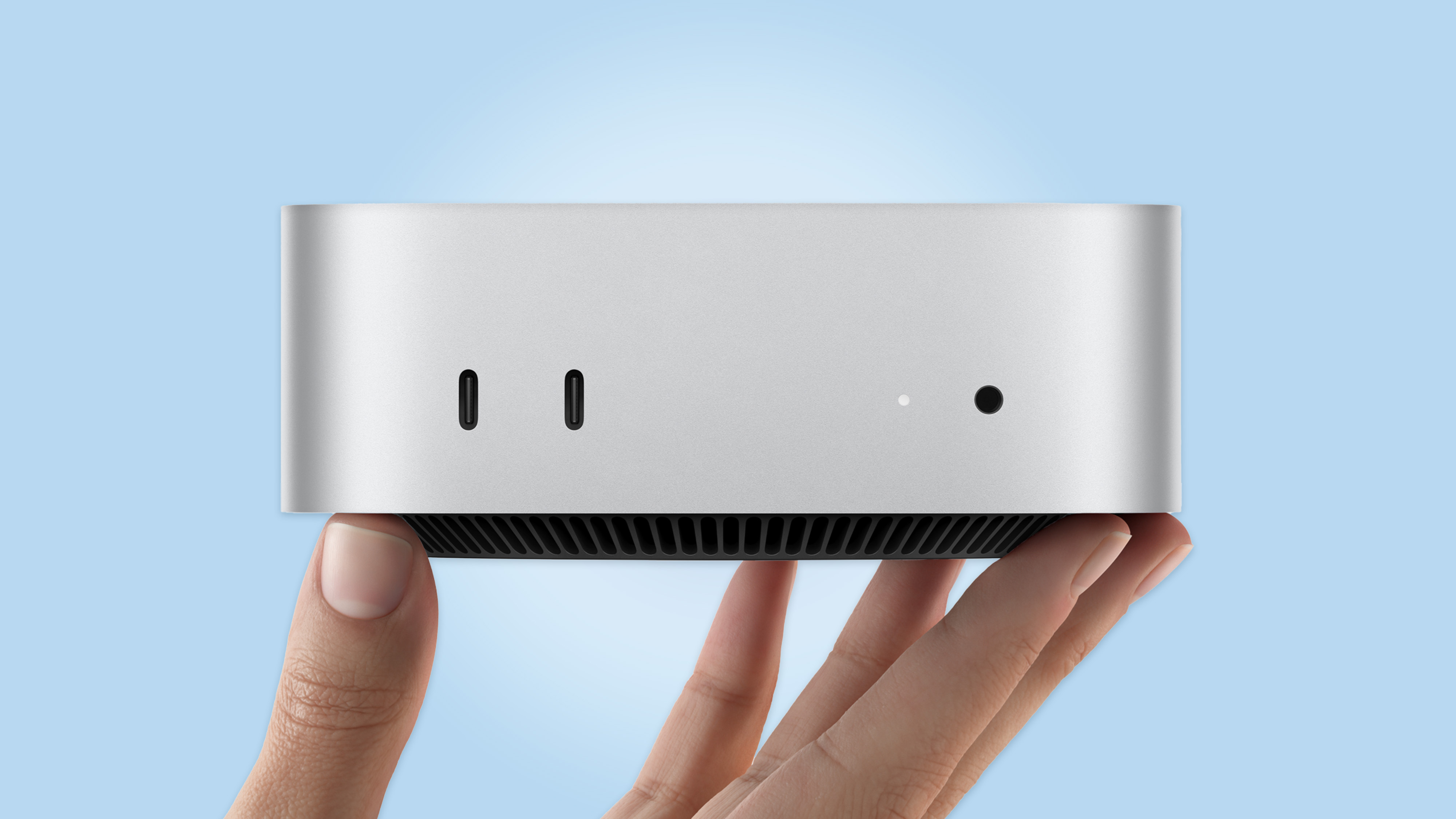 A person holding the new Mac mini with M6 in hand