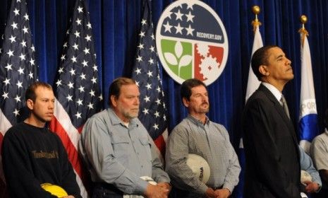 President Obama stands in front of construction workers