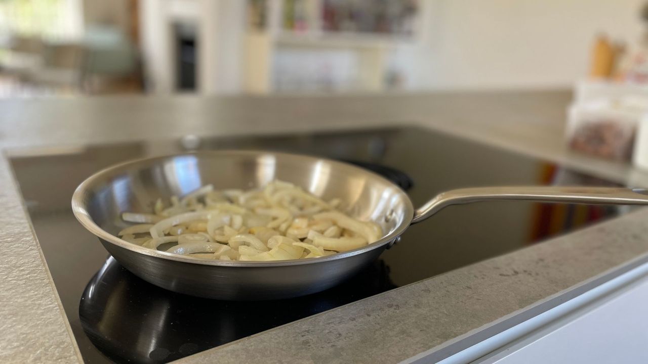 Fried onion cooking in the pan from the Made In 10-piece Stainless Steel Pan Set