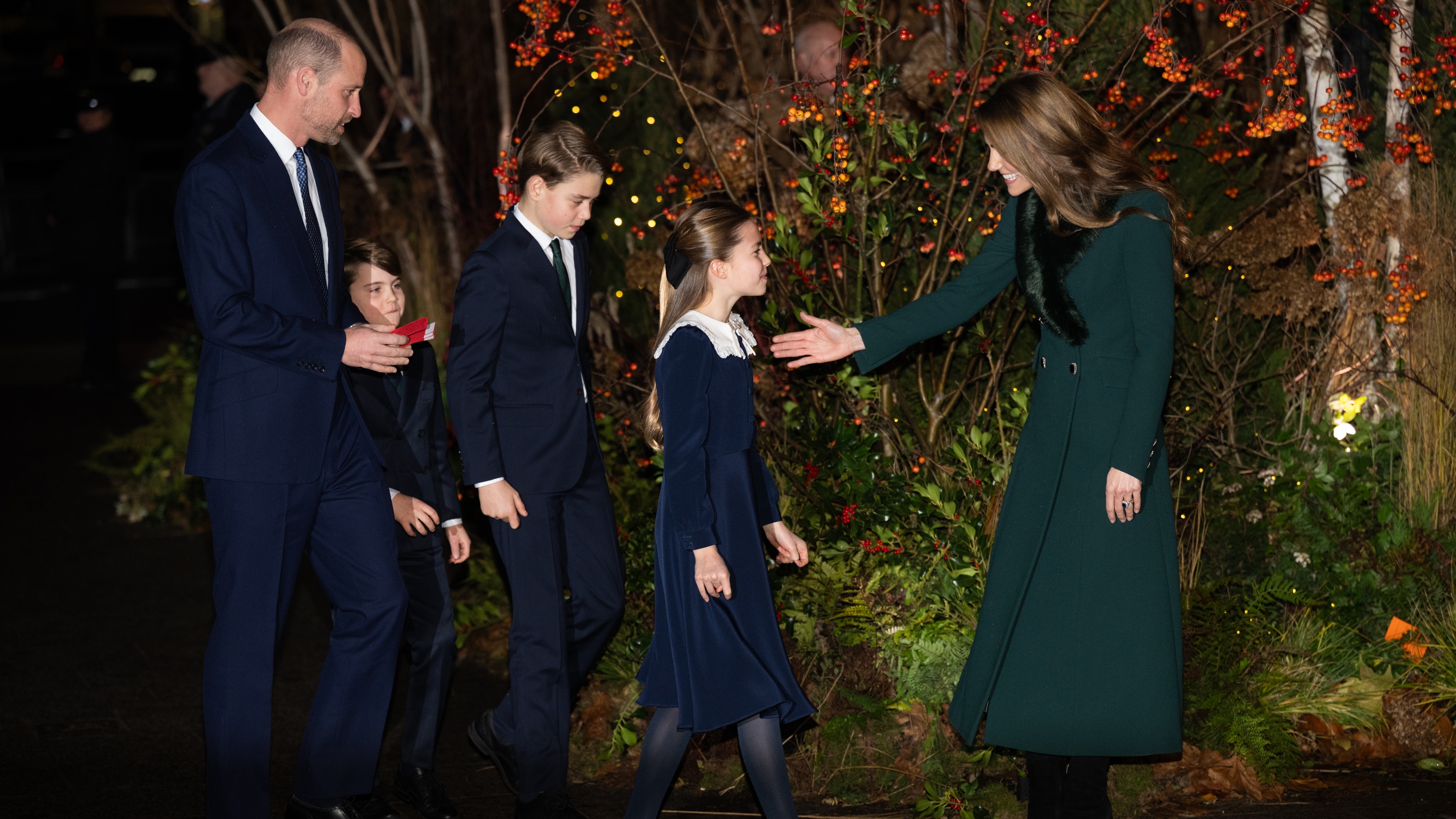 Prince William, Prince Louis of Wales, Prince George of Wales and Princess Charlotte of Wales are greeted by Catherine, Princess of Wales at the 'Together At Christmas' Carol Service
