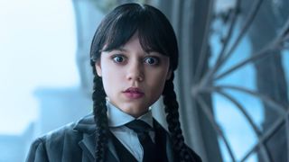 Wednesday looks shocked at something beneath her