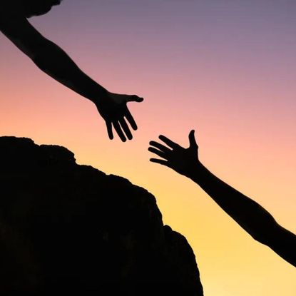 Acts of kindness: A woman reaching out to hold a friend's hand