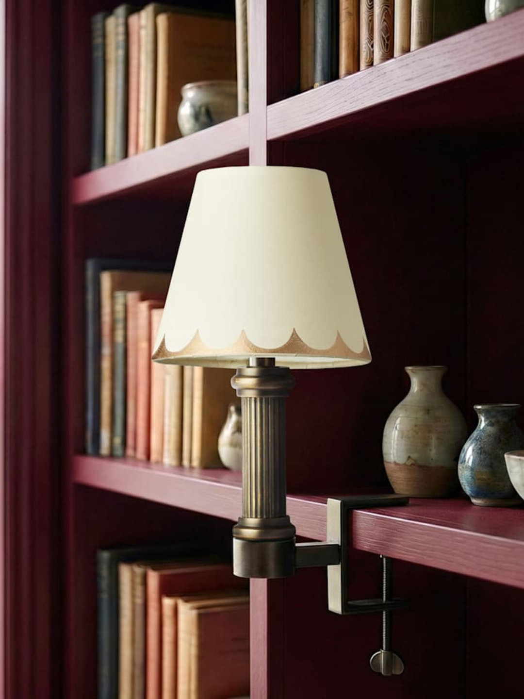 A brass rechargeable bookshelf light from Pooky