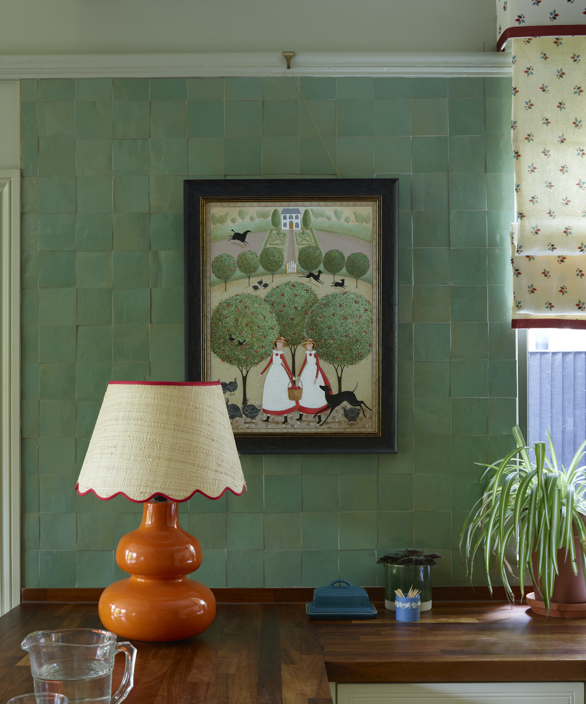 green backsplash and orange lamp