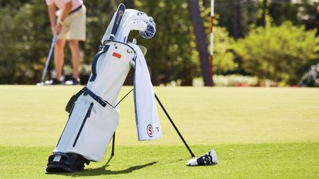 A Stitch Golf golf bag on a lush green golf course