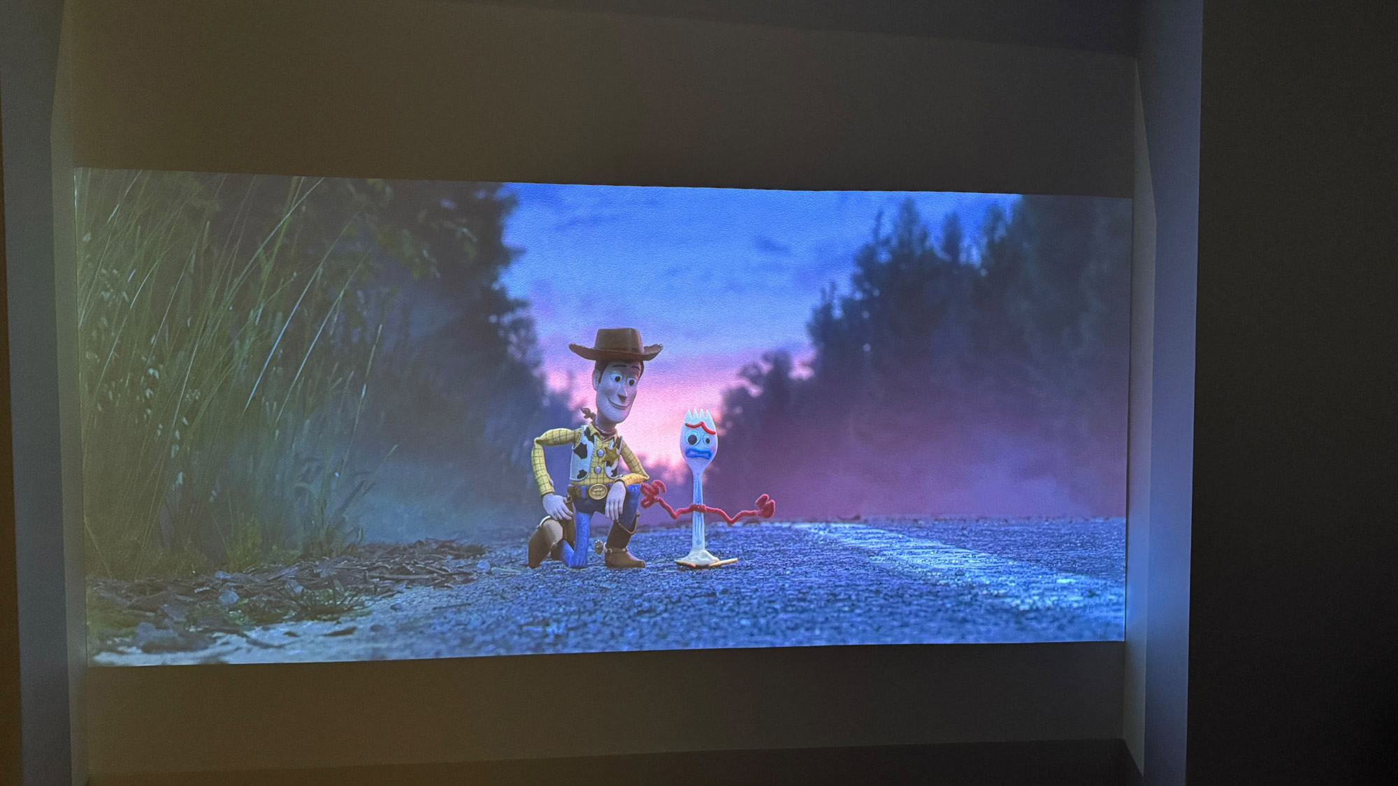 Scene from Toy Story 4 showing Woody and Spoon, projected onto a wall by the Xgimi Aura 2 projector