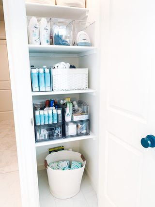 Organized linen closet with boxes on shelves