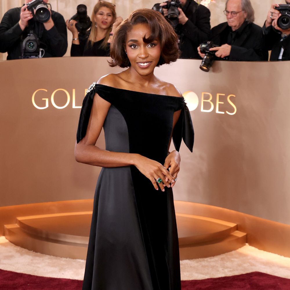 Ayo Edebiri wears a Chanel black satin and velvet dress to the Golden Globes 2026